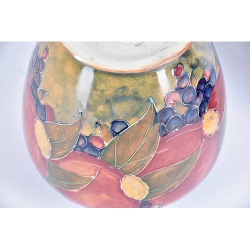 530 - An early 20th Century William Moorcroft Pomegranette vase on an ochre background, base signed W Moor... 