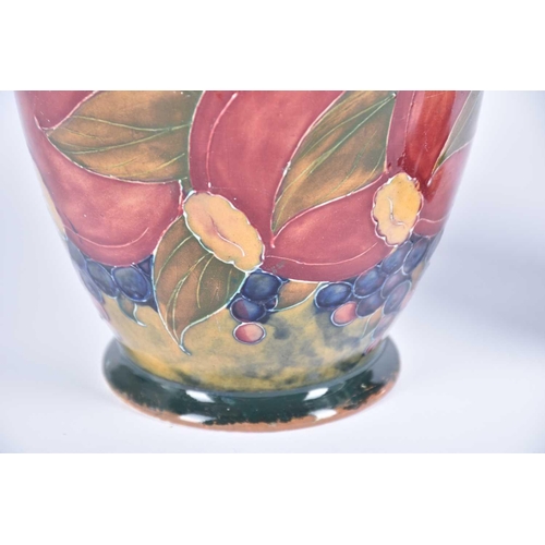 530 - An early 20th Century William Moorcroft Pomegranette vase on an ochre background, base signed W Moor... 