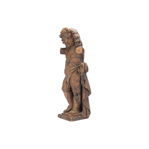 533 - An 18th century Italian carved limewood cherub figure lacking arms, in standing pose and supported o... 