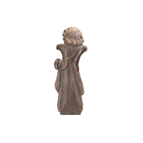 533 - An 18th century Italian carved limewood cherub figure lacking arms, in standing pose and supported o... 