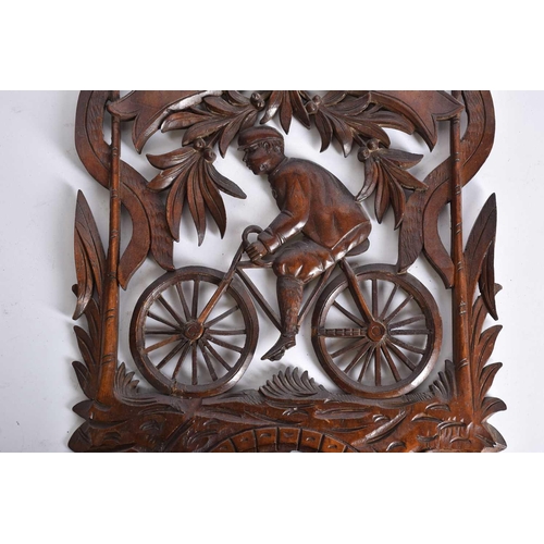 535 - A carved wood folding wall hanging shelf height 62cm, width 34.5cm, in the form of a man on a bicycl... 