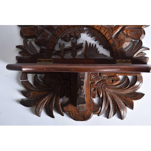 535 - A carved wood folding wall hanging shelf height 62cm, width 34.5cm, in the form of a man on a bicycl... 