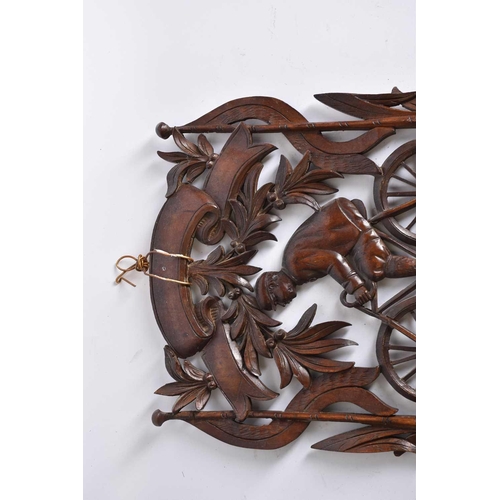 535 - A carved wood folding wall hanging shelf height 62cm, width 34.5cm, in the form of a man on a bicycl... 