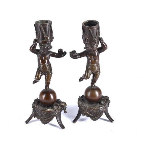 539 - A pair of late 19th-century French patinated bronze figural candlesticks, each in the form of a male... 