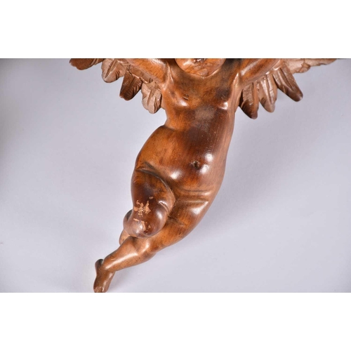 541 - A pair of 20th Century carved wood wall sconces in the form of cherubs, a rococo style giltwood wall... 