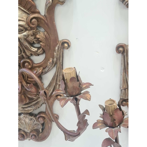 543 - A pair of carved and gilt Italianate Baroque three branch wall sconce with hanging fruit satyrs mask... 