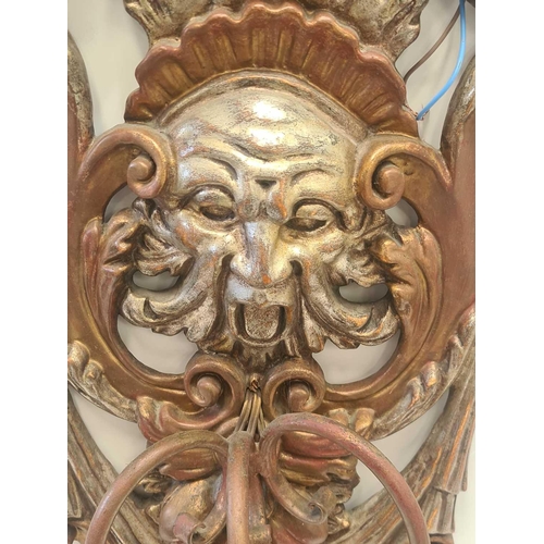 543 - A pair of carved and gilt Italianate Baroque three branch wall sconce with hanging fruit satyrs mask... 