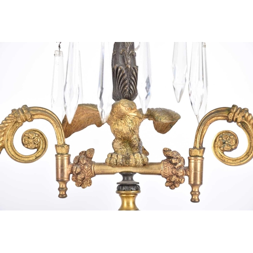 548 - An Empire period three branch candelabra,19th century, the central stem with gilt leaf from arms sus... 