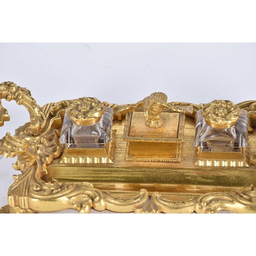 560 - A 19th century gilt bronze desk standish, the centre compartment surmounted by an eagle, flanked by ... 