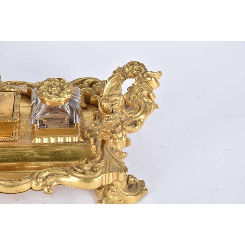 560 - A 19th century gilt bronze desk standish, the centre compartment surmounted by an eagle, flanked by ... 