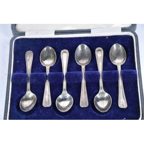 565 - A small collection of silver items to include table cruet, boxed coffee spoons, napkin rings and oth... 