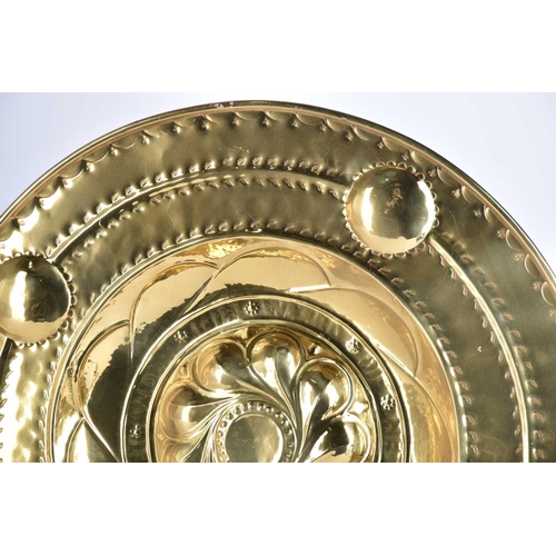 566 - A pair of Nuremberg style embossed brass alms dishes, 19th century, with central whorl bossand inscr... 