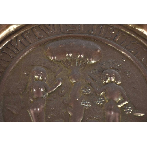 569 - A German embossed brass Adam & Eve alms dish, 17th/18th century, each titled and standing either sid... 