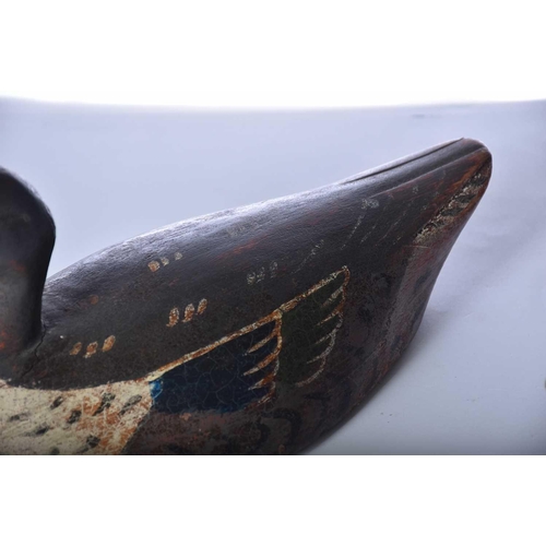 570 - Two hand carved and painted duck decoys, late 19th/early 20th century, the larger duck with a fixed ... 