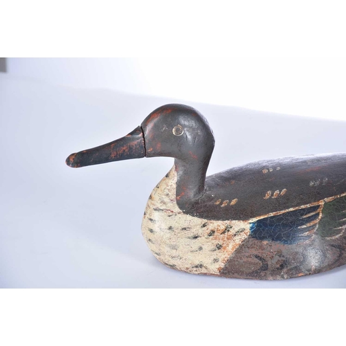 570 - Two hand carved and painted duck decoys, late 19th/early 20th century, the larger duck with a fixed ... 