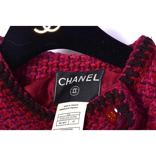 572 - A collection of Chanel couture clothing to include a short buckle jacket with matching skirt (P16222... 