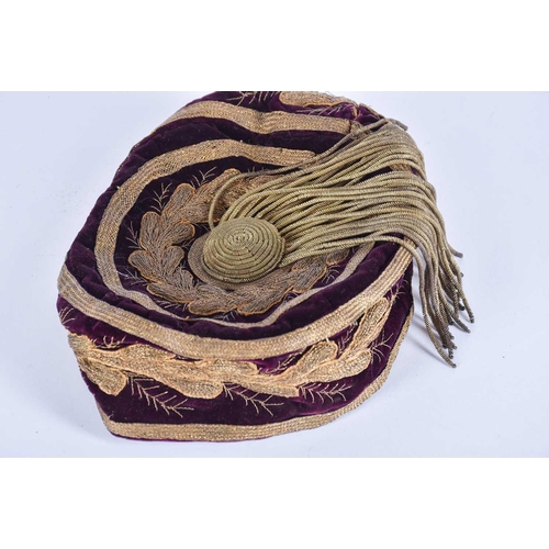 580 - A Victorian gold thread emdroidered smoking hat, with gilt thread tassel, and vintage brown leather ... 