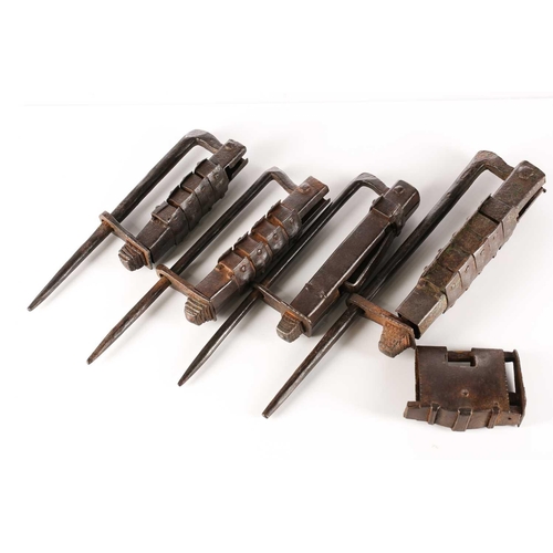 584 - A collection of four Indian wrought iron pin locks of traditional form and an Indian wrought iron pa... 