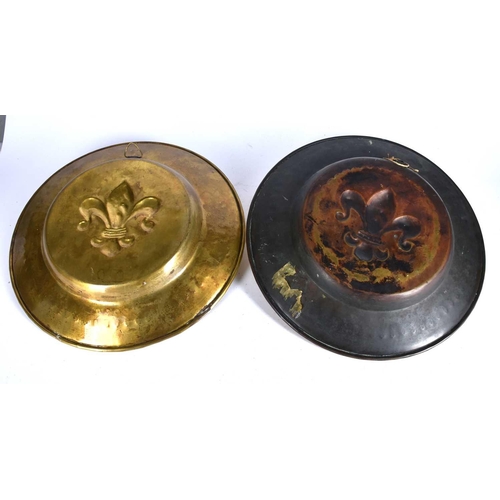 591 - A pair of 19th century Nuremberg style embossed brass alms dishes, the centre with a fleur de lis wi... 