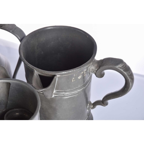 597 - A pair of pewter candlesticks and a large collection of pewter tankards and jugs, principally 19th c... 