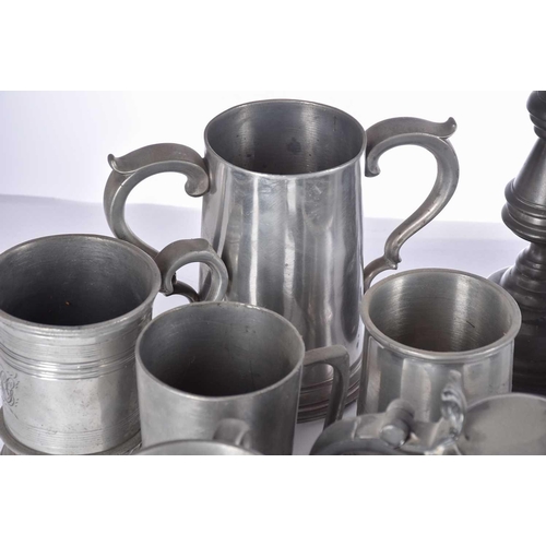 597 - A pair of pewter candlesticks and a large collection of pewter tankards and jugs, principally 19th c... 