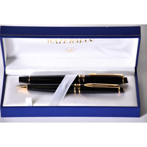 600 - A Waterman's black laquer rollerball pen with matching propelling pencil, two further Waterman ballp... 