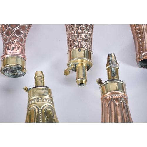 605 - A collection of ten 19th century brass and copper powder flasks, including manufacturers Dixon & Son... 