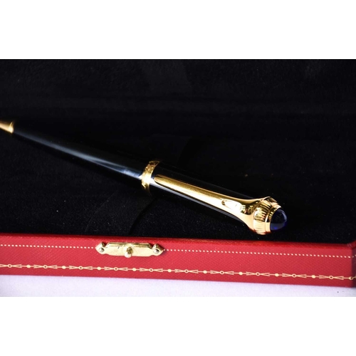 606 - A Diabolo de Cartier ballpoint pen, with blue cabochon, serial number 250610, in presentation case w... 