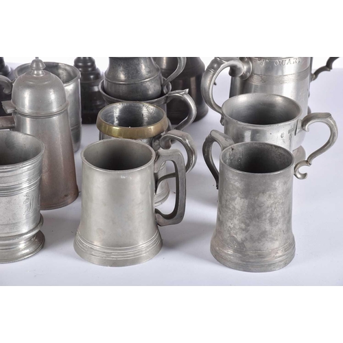 597 - A pair of pewter candlesticks and a large collection of pewter tankards and jugs, principally 19th c... 