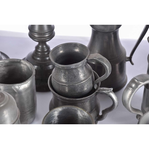 597 - A pair of pewter candlesticks and a large collection of pewter tankards and jugs, principally 19th c... 