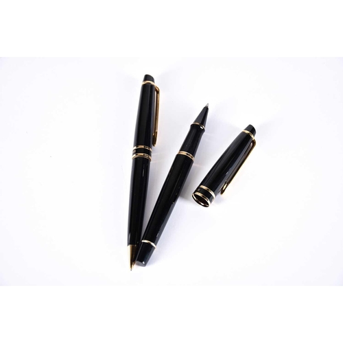 600 - A Waterman's black laquer rollerball pen with matching propelling pencil, two further Waterman ballp... 