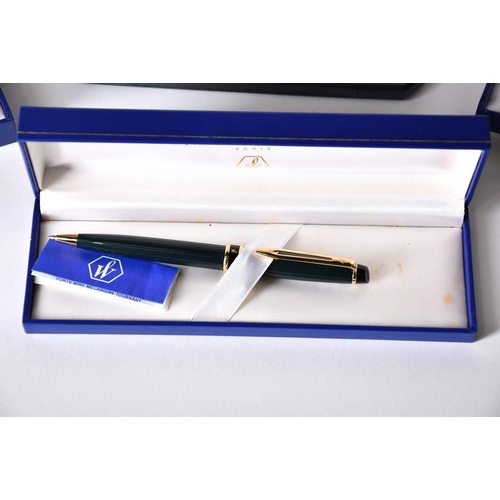 600 - A Waterman's black laquer rollerball pen with matching propelling pencil, two further Waterman ballp... 