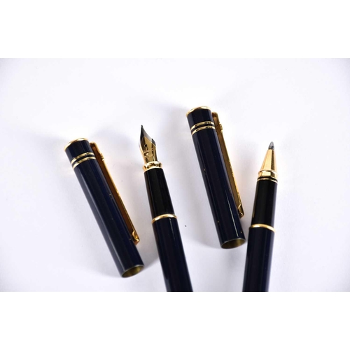 600 - A Waterman's black laquer rollerball pen with matching propelling pencil, two further Waterman ballp... 