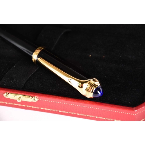 606 - A Diabolo de Cartier ballpoint pen, with blue cabochon, serial number 250610, in presentation case w... 