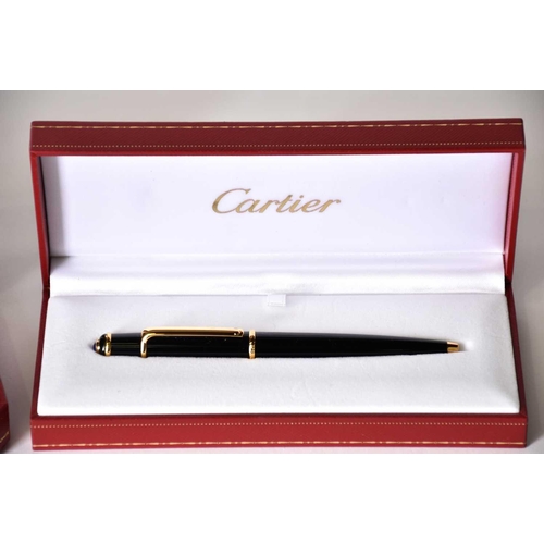 606 - A Diabolo de Cartier ballpoint pen, with blue cabochon, serial number 250610, in presentation case w... 