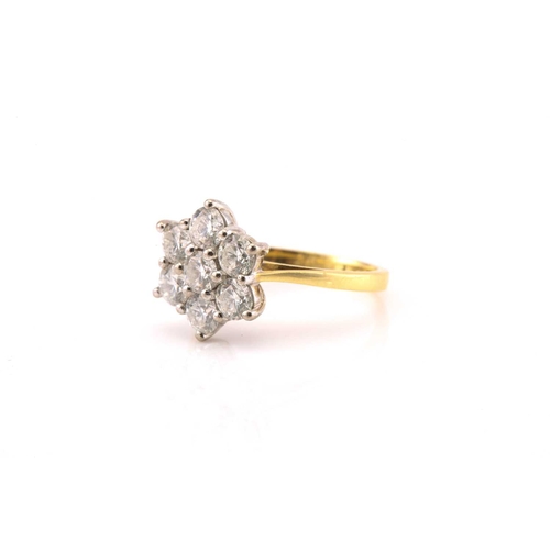 10 - An 18ct gold diamond cluster ring, comprises seven brilliant diamonds with an estimated total weight... 