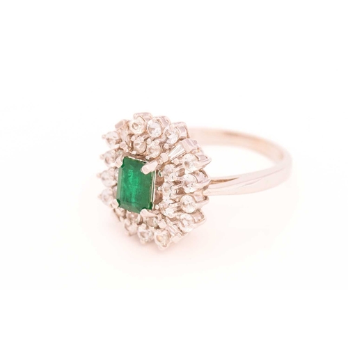 113 - An emerald and colourless sapphire cluster ring, centred with a rectangular emerald in dark green, c... 