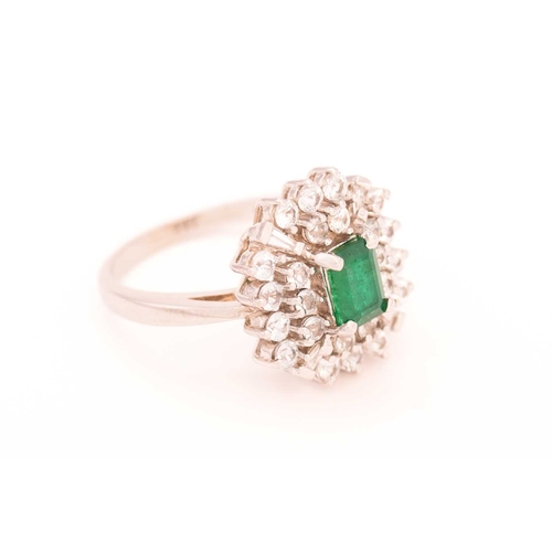 113 - An emerald and colourless sapphire cluster ring, centred with a rectangular emerald in dark green, c... 