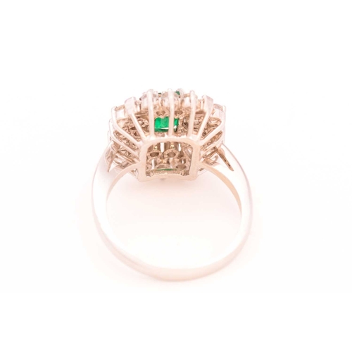 113 - An emerald and colourless sapphire cluster ring, centred with a rectangular emerald in dark green, c... 