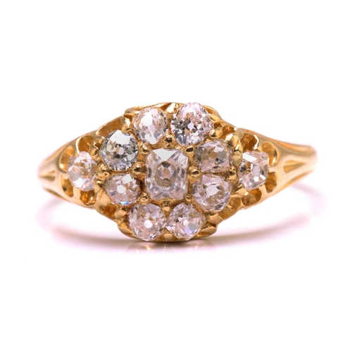 117 - A diamond cluster ring in 18ct gold, consisting of eleven multi-shaped old-cut diamonds, scintillati... 