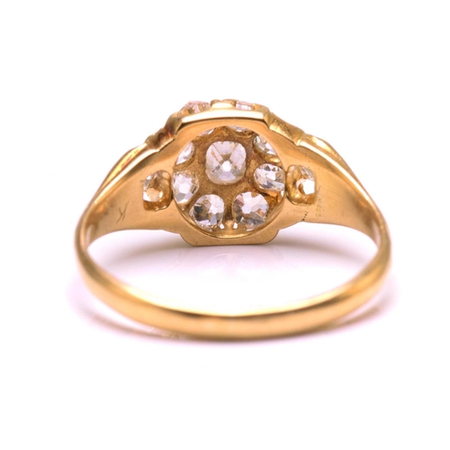 117 - A diamond cluster ring in 18ct gold, consisting of eleven multi-shaped old-cut diamonds, scintillati... 