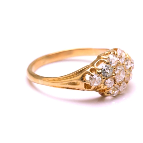 117 - A diamond cluster ring in 18ct gold, consisting of eleven multi-shaped old-cut diamonds, scintillati... 