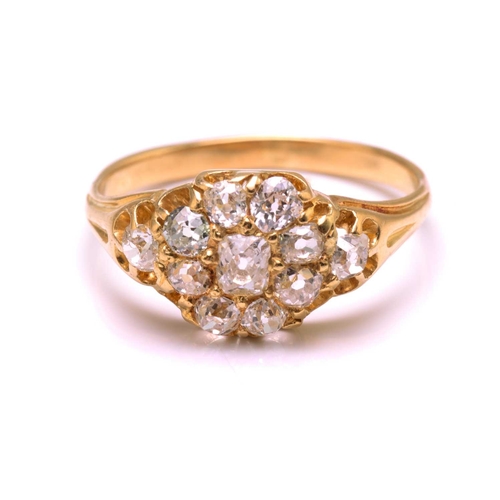 117 - A diamond cluster ring in 18ct gold, consisting of eleven multi-shaped old-cut diamonds, scintillati... 