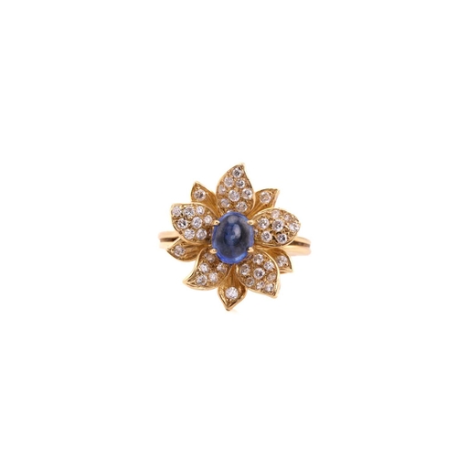 118 - An 18ct gold sapphire and diamond flower ring, comprises an oval sapphire cabochon with a high dome,... 