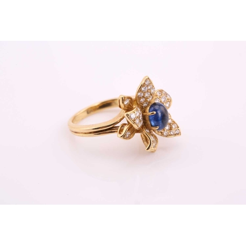 118 - An 18ct gold sapphire and diamond flower ring, comprises an oval sapphire cabochon with a high dome,... 