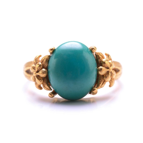119 - A turquoise dress ring, featuring an oval turquoise cabochon approximately measures 11.8 x 9.9 mm, c... 