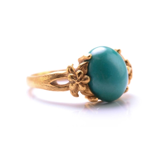 119 - A turquoise dress ring, featuring an oval turquoise cabochon approximately measures 11.8 x 9.9 mm, c... 