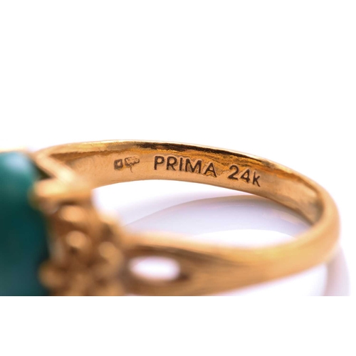 119 - A turquoise dress ring, featuring an oval turquoise cabochon approximately measures 11.8 x 9.9 mm, c... 