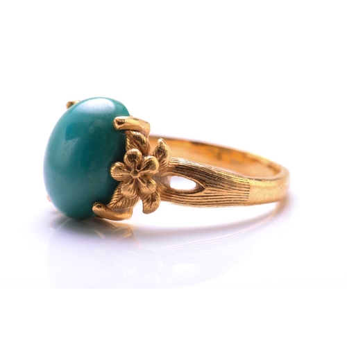 119 - A turquoise dress ring, featuring an oval turquoise cabochon approximately measures 11.8 x 9.9 mm, c... 