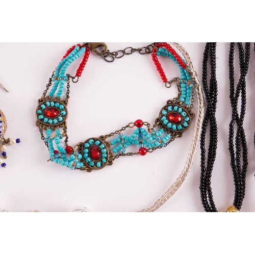 12 - A quantity of costume jewellery, to include examples of an 18ct gold Victorian crescent and star bro... 